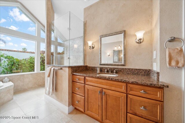 649 Spring Lake Dr, Melbourne, FL 32940 - full bathroom with vanity, a tile shower, tile patterned floors, and vaulted ceiling