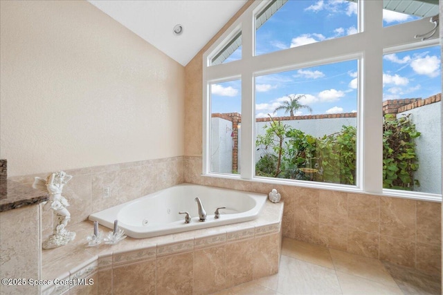 649 Spring Lake Dr, Melbourne, FL 32940 - full bathroom with a jetted tub, vaulted ceiling, and tile patterned flooring
