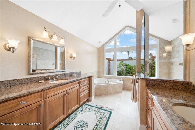 649 Spring Lake Dr, Melbourne, FL 32940 - bathroom with two vanities, a garden tub, vaulted ceiling, tile patterned flooring, and ceiling fan