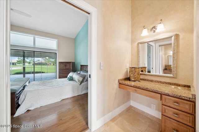 649 Spring Lake Dr, Melbourne, FL 32940 - ensuite bathroom featuring baseboards and vanity