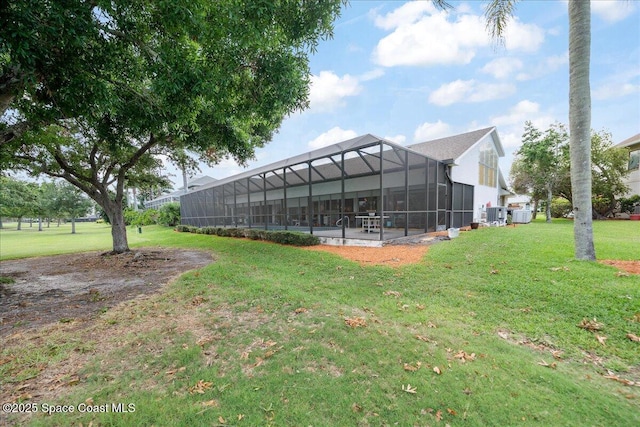 649 Spring Lake Dr, Melbourne, FL 32940 - view of green lawn featuring central AC and glass enclosure