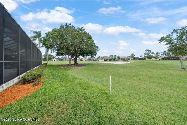 649 Spring Lake Dr, Melbourne, FL 32940 - view of grassy yard featuring a residential view and glass enclosure