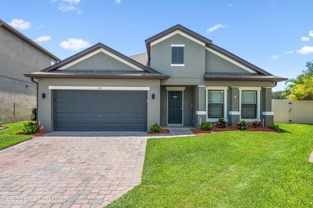 4065 Harvest Cir, Rockledge, FL 32955 - view of front of property featuring stucco siding, decorative driveway, an attached garage, and a gate