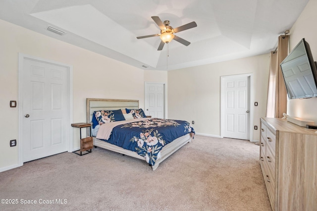 4065 Harvest Cir, Rockledge, FL 32955 - bedroom featuring a raised ceiling, light carpet, baseboards, and a ceiling fan