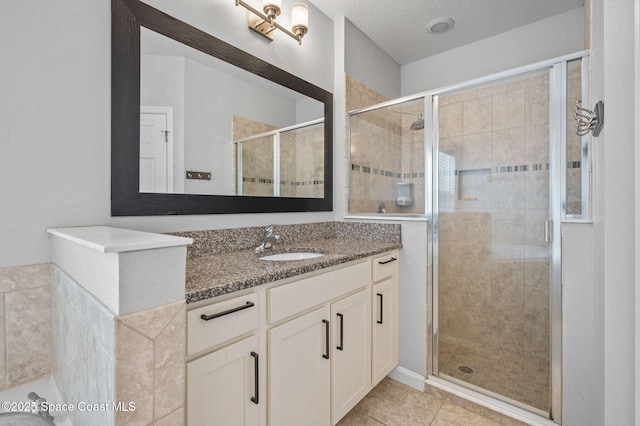 4065 Harvest Cir, Rockledge, FL 32955 - full bathroom with a shower stall, vanity, tile patterned flooring, and a textured ceiling