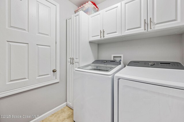 4065 Harvest Cir, Rockledge, FL 32955 - laundry room with washer and dryer, cabinet space, baseboards, and light tile patterned floors