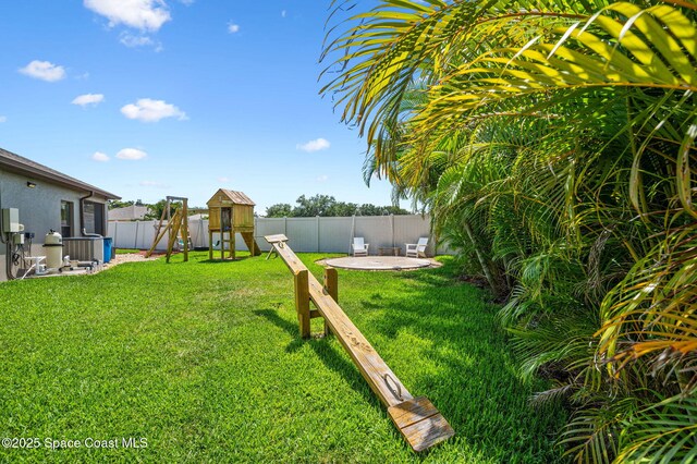 4065 Harvest Cir, Rockledge, FL 32955 - view of yard with a patio, a playground, and a storage shed