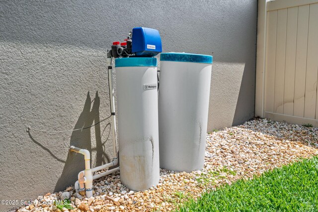 4065 Harvest Cir, Rockledge, FL 32955 - exterior view of a water softener and stucco siding