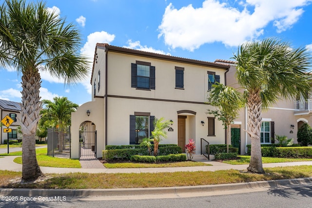 6794 Vista Hermosa Dr, Melbourne, FL 32940 - view of front of house featuring stucco siding and a gate