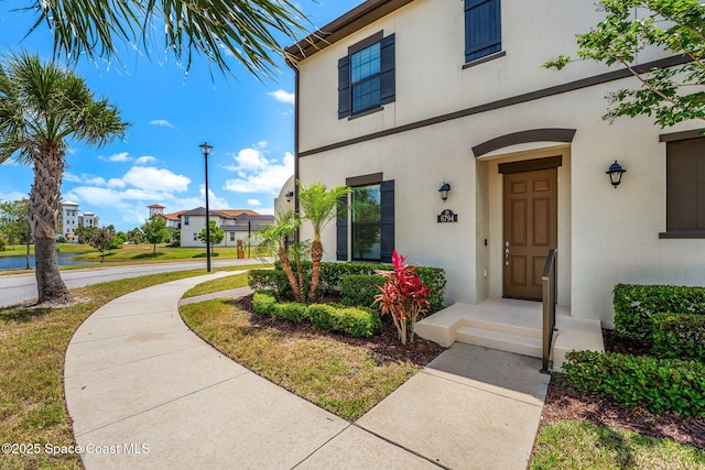 6794 Vista Hermosa Dr, Melbourne, FL 32940 - property entrance with stucco siding and a residential view