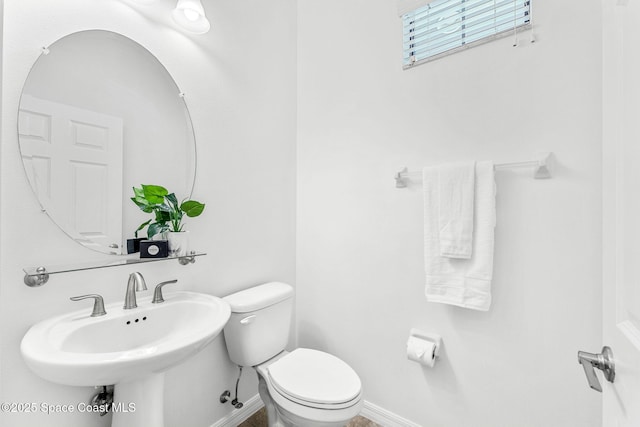 6794 Vista Hermosa Dr, Melbourne, FL 32940 - bathroom featuring toilet, baseboards, and a sink