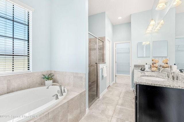 6794 Vista Hermosa Dr, Melbourne, FL 32940 - bathroom with a spacious closet, a shower stall, a bath, and double vanity