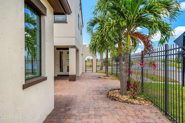 6794 Vista Hermosa Dr, Melbourne, FL 32940 - view of patio / terrace featuring french doors, fence, and a gate