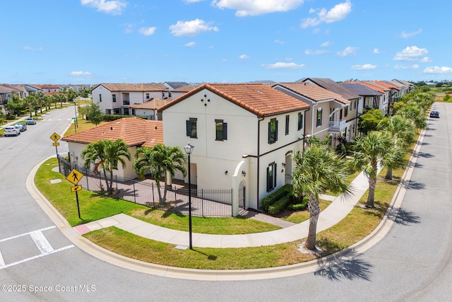 6794 Vista Hermosa Dr, Melbourne, FL 32940 - view of front of property featuring a residential view, fence, stucco siding, and a tiled roof