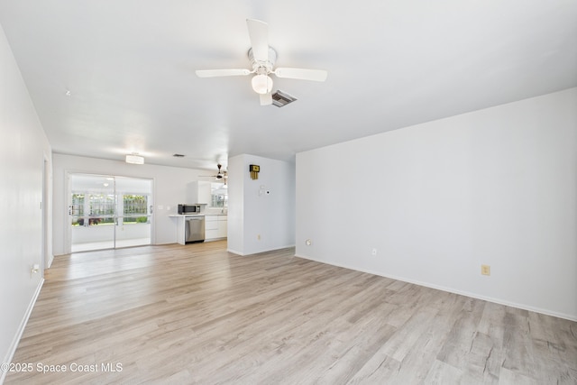 959 Eyerly Ln NE, Palm Bay, FL 32905 - unfurnished living room featuring a ceiling fan and light wood-style floors