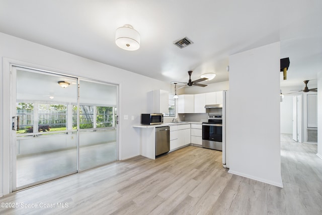959 Eyerly Ln NE, Palm Bay, FL 32905 - kitchen featuring appliances with stainless steel finishes, a ceiling fan, white cabinets, light wood finished floors, and light countertops