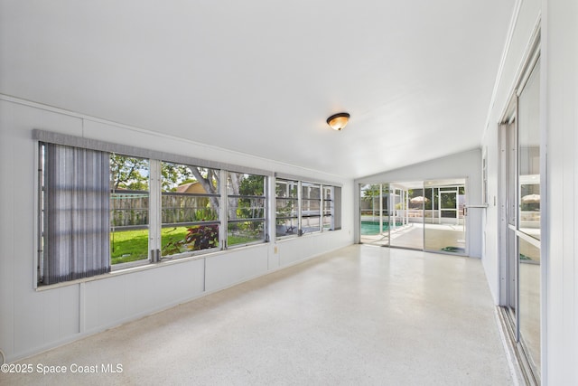 959 Eyerly Ln NE, Palm Bay, FL 32905 - unfurnished sunroom featuring vaulted ceiling and speckle patterned floor