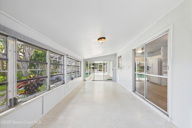 959 Eyerly Ln NE, Palm Bay, FL 32905 - unfurnished sunroom featuring vaulted ceiling and speckle patterned floor