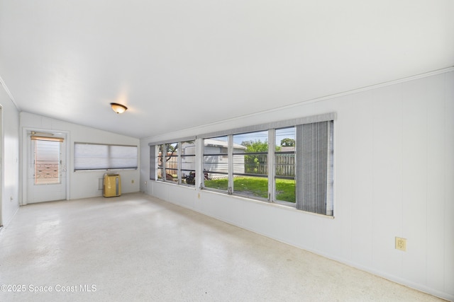 959 Eyerly Ln NE, Palm Bay, FL 32905 - empty room with healthy amount of natural light, lofted ceiling, and speckle patterned floor