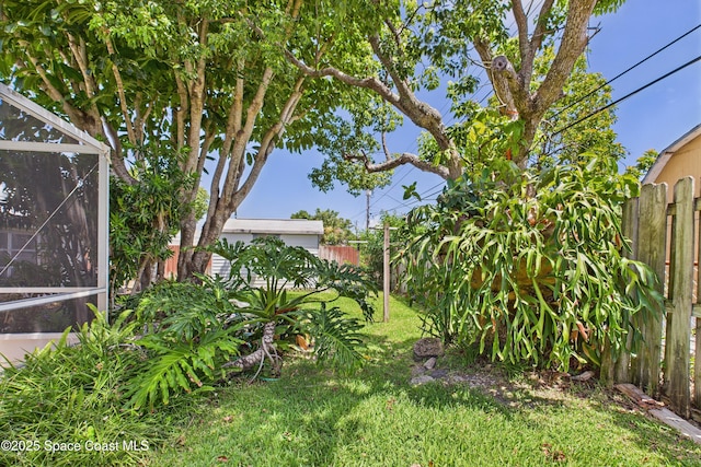 959 Eyerly Ln NE, Palm Bay, FL 32905 - fenced backyard featuring glass enclosure
