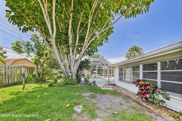 959 Eyerly Ln NE, Palm Bay, FL 32905 - fenced backyard featuring an outdoor pool and glass enclosure