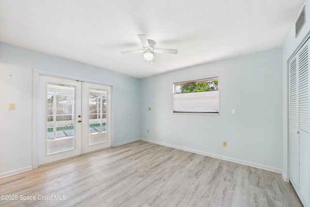 959 Eyerly Ln NE, Palm Bay, FL 32905 - unfurnished bedroom with french doors, access to exterior, light wood-style flooring, a closet, and a ceiling fan