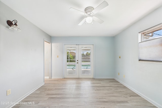 959 Eyerly Ln NE, Palm Bay, FL 32905 - empty room featuring a ceiling fan, french doors, and light wood-style flooring