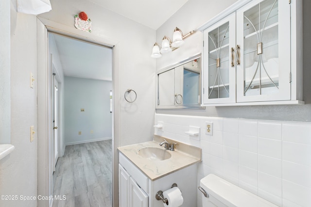 959 Eyerly Ln NE, Palm Bay, FL 32905 - half bathroom featuring vanity, wood finished floors, and tile walls