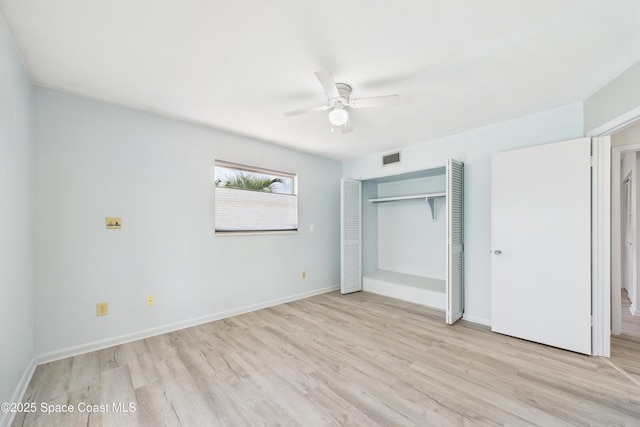 959 Eyerly Ln NE, Palm Bay, FL 32905 - unfurnished bedroom with light wood-style floors, a closet, and ceiling fan