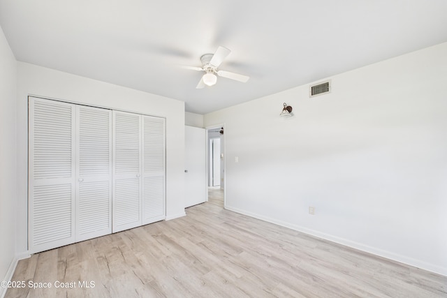 959 Eyerly Ln NE, Palm Bay, FL 32905 - unfurnished bedroom with wood finished floors, a closet, and a ceiling fan