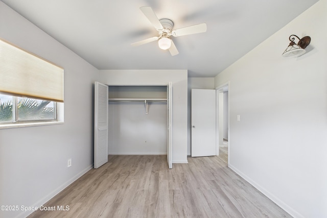 959 Eyerly Ln NE, Palm Bay, FL 32905 - unfurnished bedroom with light wood-style flooring, a closet, and a ceiling fan