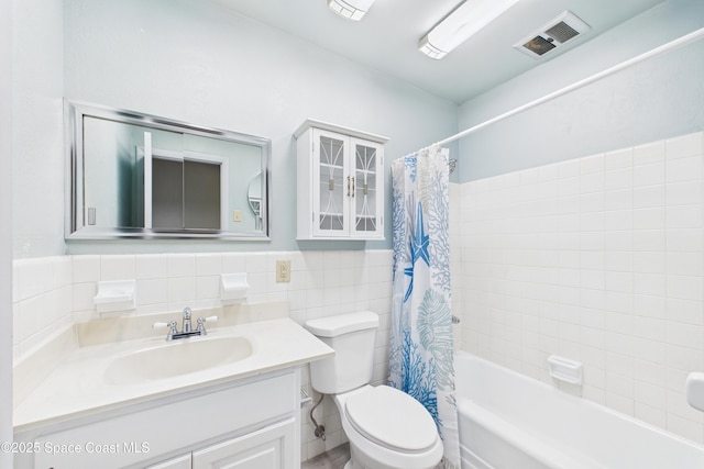 959 Eyerly Ln NE, Palm Bay, FL 32905 - full bath featuring tile walls, vanity, shower / tub combo, and a wainscoted wall