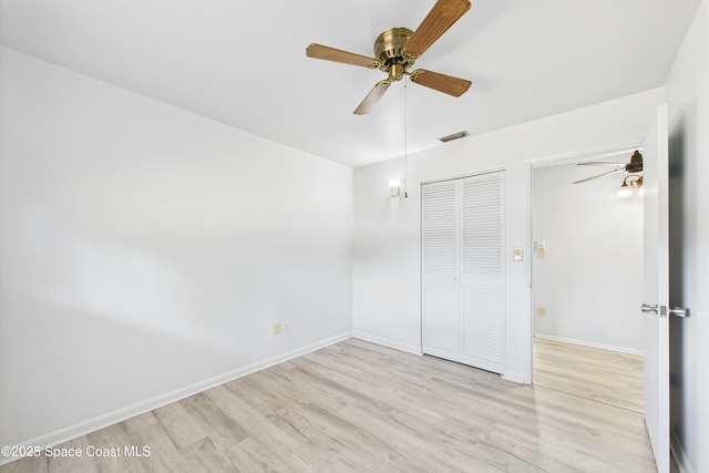 959 Eyerly Ln NE, Palm Bay, FL 32905 - unfurnished bedroom featuring light wood finished floors, a closet, and a ceiling fan