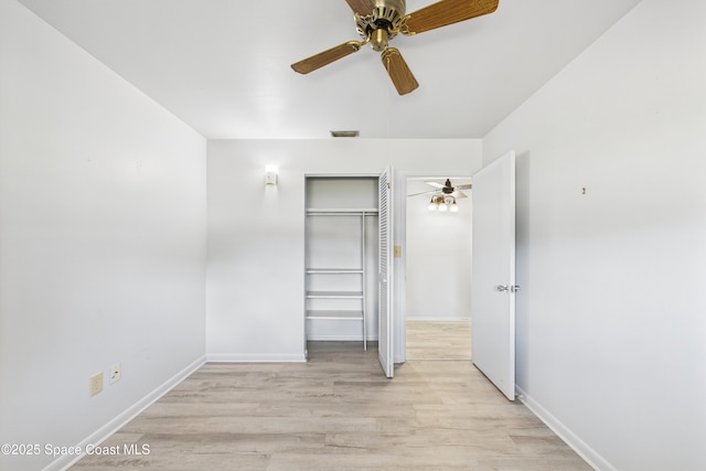 959 Eyerly Ln NE, Palm Bay, FL 32905 - unfurnished bedroom featuring light wood-style floors, a closet, and ceiling fan