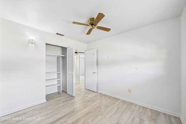 959 Eyerly Ln NE, Palm Bay, FL 32905 - unfurnished bedroom with a closet, wood finished floors, and ceiling fan