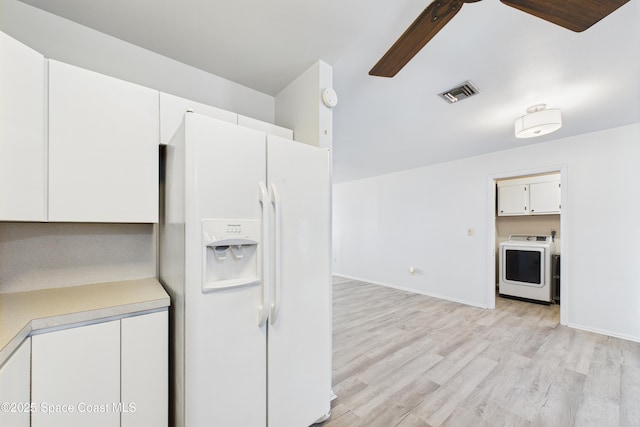 959 Eyerly Ln NE, Palm Bay, FL 32905 - kitchen featuring white fridge with ice dispenser, light countertops, light wood-style flooring, white cabinetry, and a ceiling fan