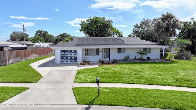 959 Eyerly Ln NE, Palm Bay, FL 32905 - view of front of property with a garage, concrete driveway, roof mounted solar panels, and a porch