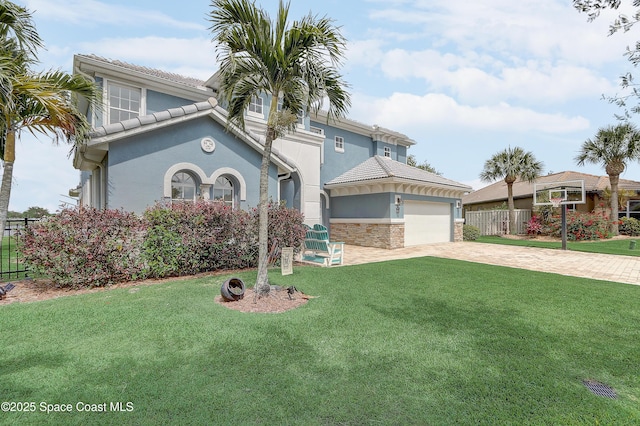 mediterranean / spanish-style house featuring stucco siding, driveway, a garage, and a tile roof