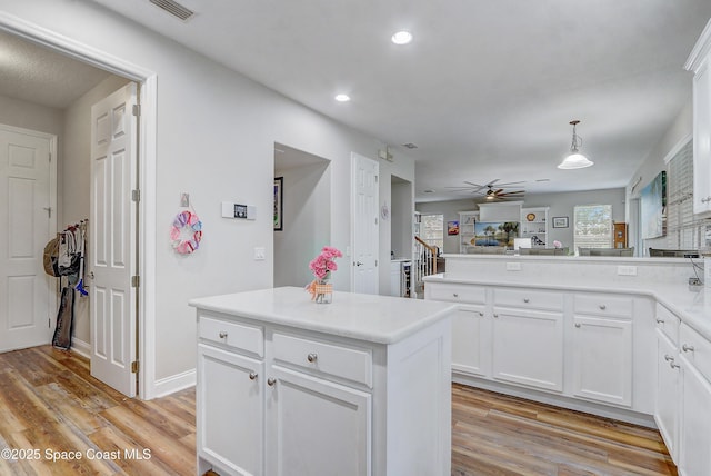 kitchen with light wood-style flooring, ceiling fan, recessed lighting, a peninsula, and white cabinetry