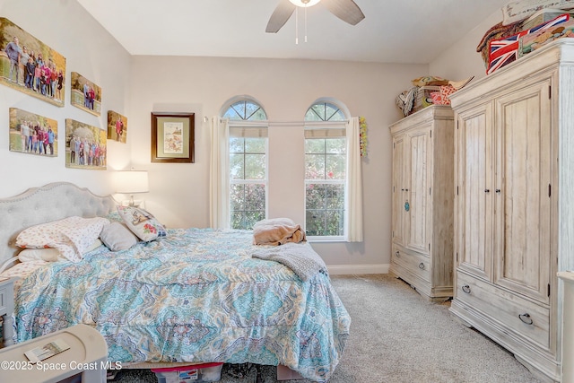 bedroom with light carpet, baseboards, and ceiling fan