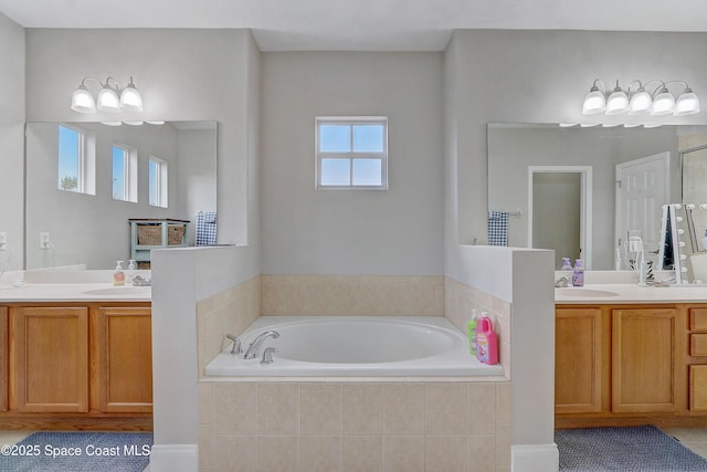 full bath featuring a garden tub and two vanities