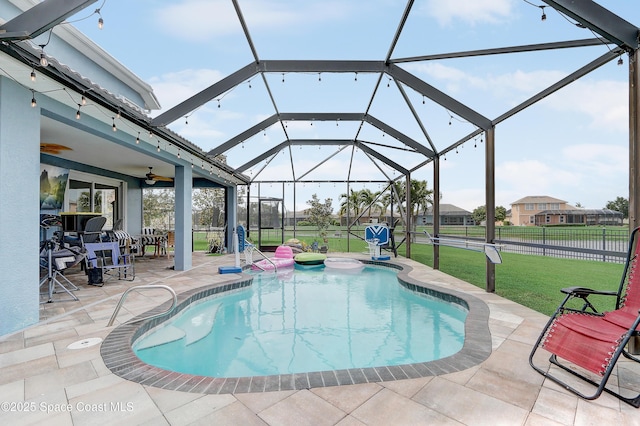 swimming pool featuring a patio, ceiling fan, and glass enclosure