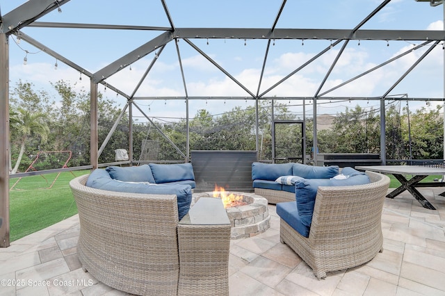 view of patio / terrace with an outdoor living space with a fire pit and glass enclosure
