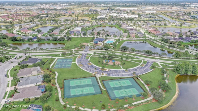 aerial view of property's location featuring a nearby body of water and nearby suburban area