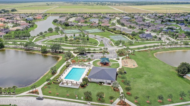 drone / aerial view of a large body of water and a pool