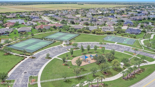 aerial view of property and surrounding area featuring a nearby body of water