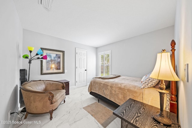 bedroom with marble finish flooring