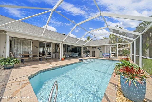 outdoor pool with a patio, an outdoor hangout area, and a lanai