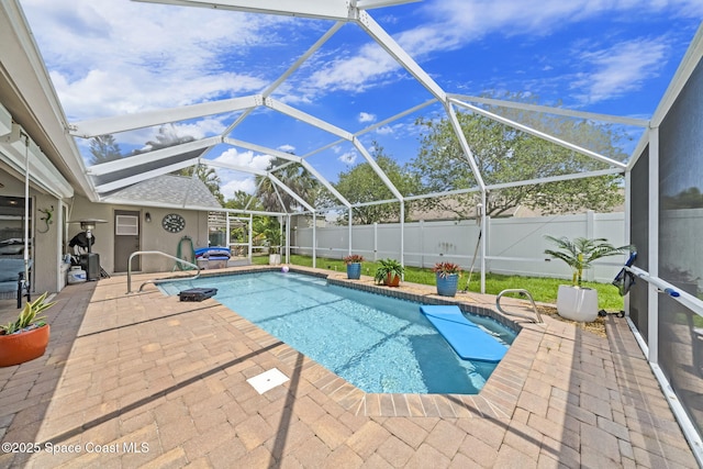 view of swimming pool with a patio area, a fenced backyard, and a lanai