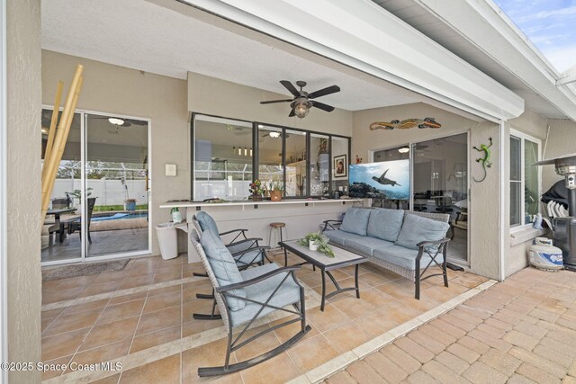 view of patio / terrace with ceiling fan and an outdoor living space
